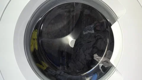 Close up view of a Washing Machine in Action Spinning Laundry Load Stock Footage 294106500