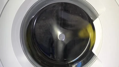Close up view of a Washing Machine in Action Spinning Laundry Load Stock Footage 294106600