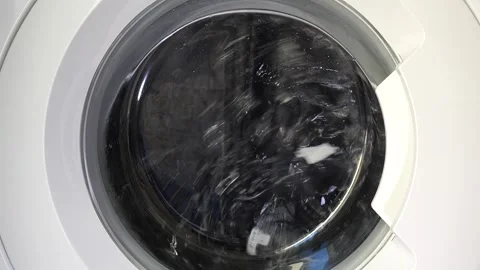 Close up view of a Washing Machine in Action Spinning Laundry Load Stock Footage 294107164