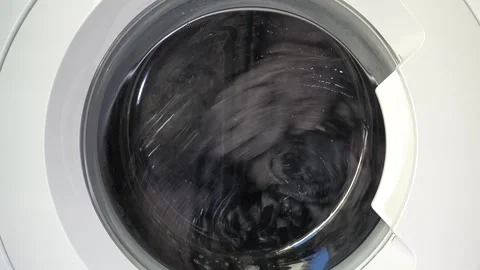 Close up view of a Washing Machine in Action Spinning Laundry Load Stock Footage 294107588