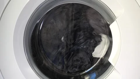 Close up view of a Washing Machine in Action Spinning Laundry Load Stock Footage 294107676