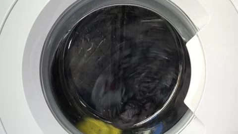Close up view of a Washing Machine in Action Spinning Laundry Load Stock Footage 294107757