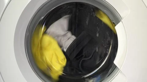 Close up view of a Washing Machine in Action Spinning Laundry Load Stock Footage 294108595