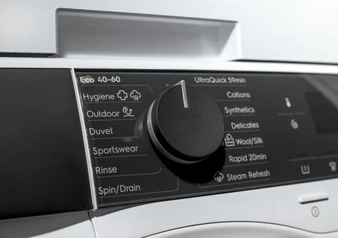 Close view of washing machine control dial and display. Front loading applian 스톡 사진