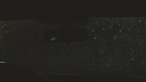 Close view of water and detergent on windscreen or windshield of car in drive Stock Footage 129303680