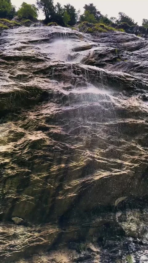 Close View of Water Cascading Over Alpine Rocks. Stock Footage 328462243