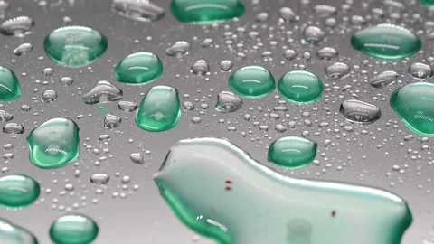 Close view of water droplets on shiny surface reflecting light in a room Stock Footage 331997163