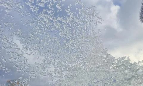 Close-up view of water droplets on a windshield, creating a textured pattern Stock Photos