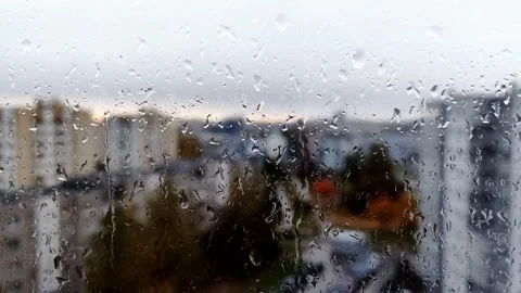 Close up view of water drops falling on glass. Rain running down on window Stock Footage 141383639