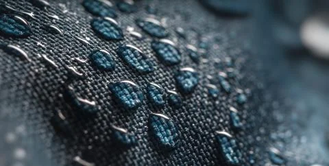 Close-up view on water drops on waterproof impregnated fabric in rain. Stock Photos