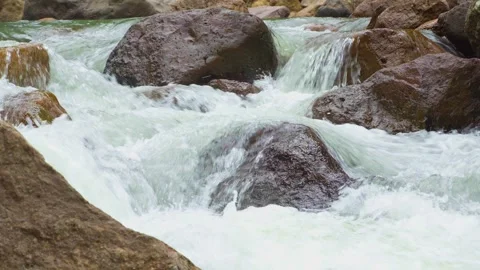 Close up view, Waterfall flowing through rock layers into a pool Stock Footage 282518463