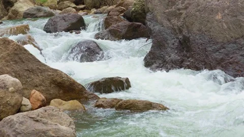 Close up view, Waterfall flowing through rock layers into a pool Stock Footage 282519013