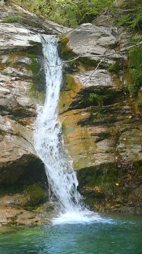 Close-up view of a waterfall in vertical format. Slow Motion. Stock Footage 311985037