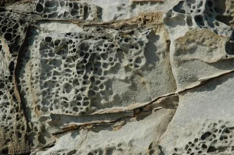 A close-up view of weathered and eroded rocks. Stock Photos