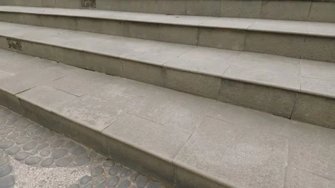 Close up view of weathered outdoor stone steps leading up in an urban setting. Video stock 343368544