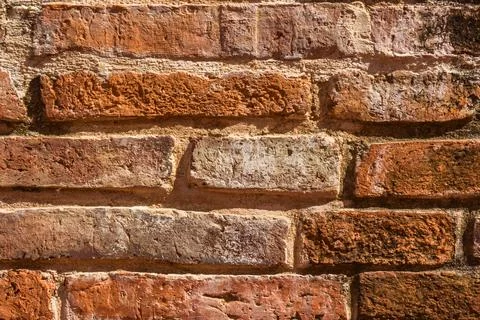 Close up view of weathered textured red brick wall surface Stock Photos