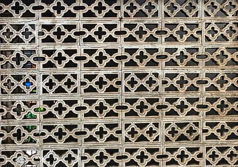 A close-up view of a weathered wall made of stacked rectangular blocks with c Stock Photos