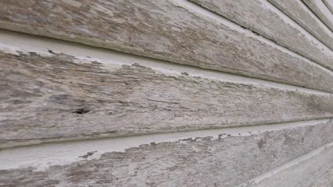 Close-up view of a weathered white wooden wall with peeling paint Stock Footage 345871852
