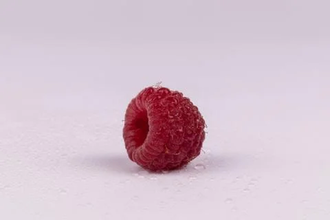 Close view of wet raspberry with small drops of water on it Stock Photos