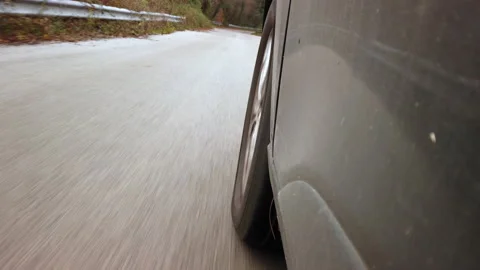 Close-up view of a wheel. Tire on the road of a car turning in the woods Stock Footage 227756704