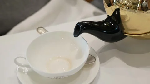 Close up view of white ceramic cup while pouring fresh brew english black t.. Stock Footage 281834563