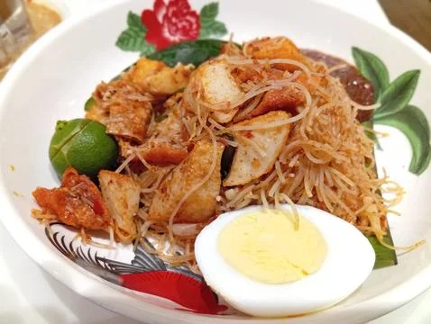 Close-up view of a white ceramic platter with Chinese fried noodles, half o.. Stock Photos