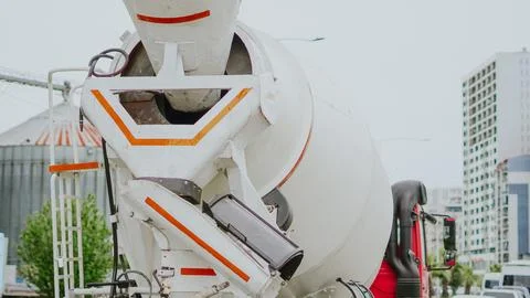 A close up view of a white construction concrete mixer truck focusing on the  Stock Photos