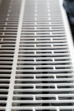 Close-up view of a white heating vent with slatted openings, showcasing modern Stock Photos
