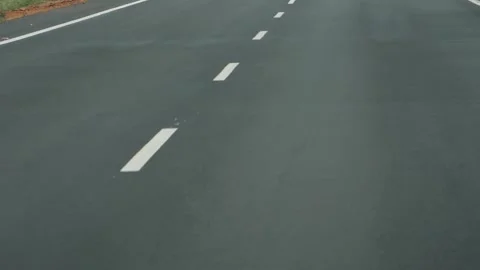 Close view of white lines in center of double lane road Stock Footage 156972459