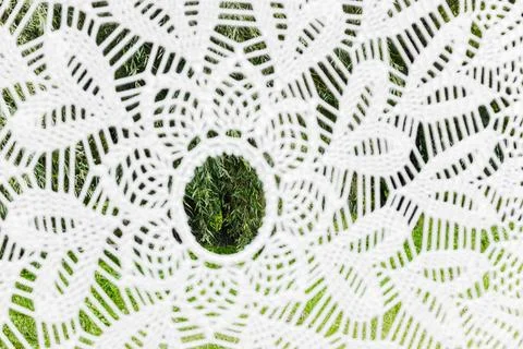 Close-up view of a white macrame hammock's detailed pattern, revealing blurre Stock Photos