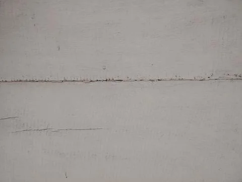 Close up view of white painted wall showing subtle cracks and texture details 写真素材