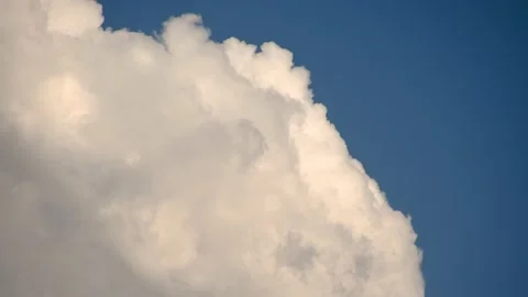 Close up view of white puffy fluffy white clouds against blue sky Stock Footage 157107499