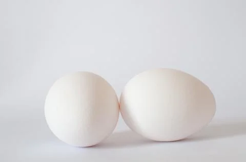 Close up view of white raw chicken eggs isolated on white background. Stock Photos