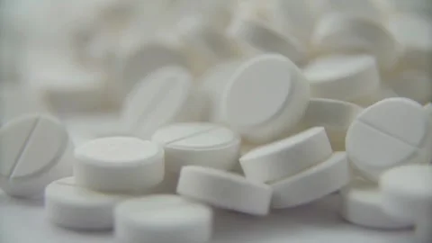 Close up view of white round medical pills pile Stock Footage 333836403