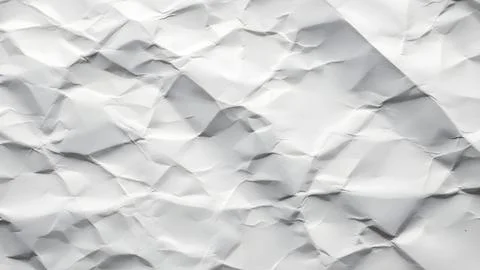 Close up view of a white sheet of crumpled paper with deep shadows and orga.. Fotos de archivo