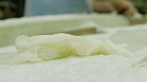 Close up view of white silicone glove on white synthetic fibre Stock Footage 99571901