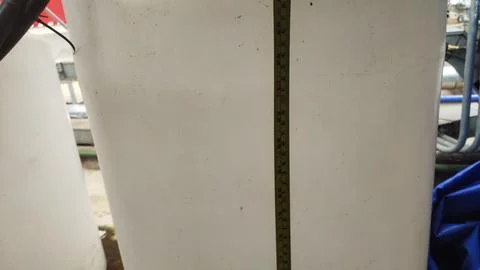 A close-up view of a white surface with a measuring tape alongside it. Stock Photos