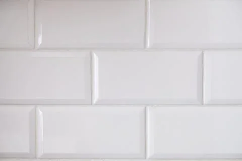 Close up view of white tiled kitchen wall. Typical interior design idea. Stock Photos