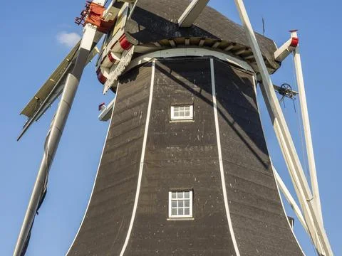 Close-up view of the wings and the upper part of a windmill in sunny weather, Stock Photos