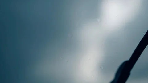 Close view wiper cleans raindrops on car windshield quickly Stock Footage 104322238