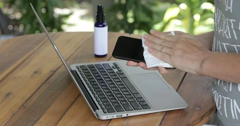 Close up view of woman hand using antibacterial wet wipe for disinfecting phone Stock Footage 126949399