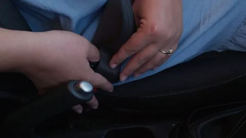 Close up view of a woman hands locking the seatbelt buckle before driving h.. Stock Footage 338226456