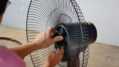 Close-up view of a woman installing the table fan. 動画素材 119618870