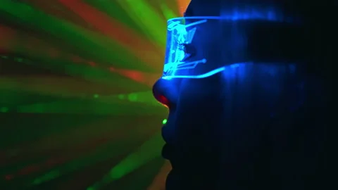 The close up view on a woman in interactive glasses on the laser rays background Stock Footage 191446885
