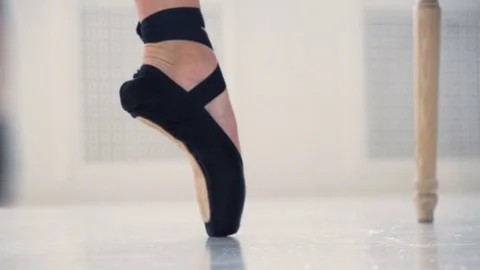 Close up view woman put on black pointe ballet footwear to practice ballet dance Video stock 77292575