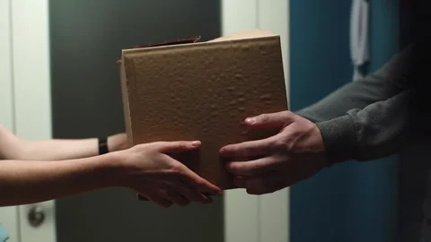 Close-up view of woman receiving parcel at home from delivery man hands on Stock Footage 146592995