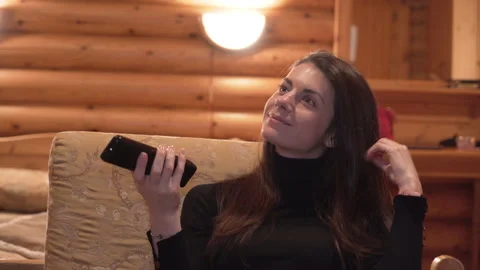 Close view of woman with remote control in hand playing with her hair Stock Footage 152447707