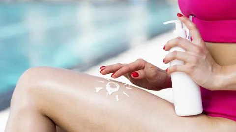 Close up view woman using sunscreen. High quality photo Stock Photos