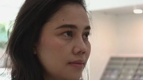 Close-up view of woman's face and eyes inside eyeglasses clinic Stock Footage 242824190