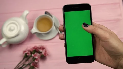 Close up view of womans hand, finger scrolling pages, feed on mobile phone with Stock Footage 73910939